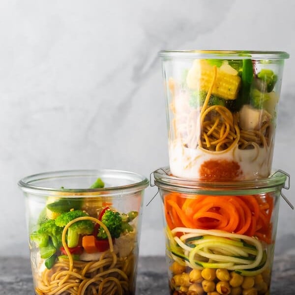 three jars with homemade instant noodles on gray background