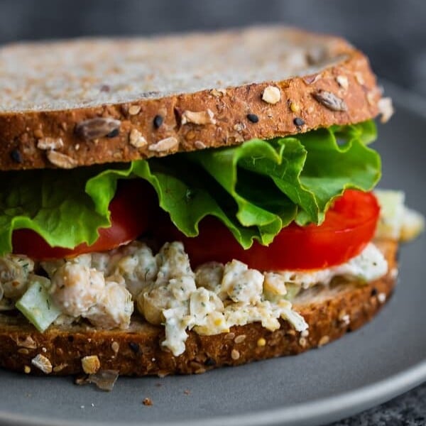 close up view of chickpea salad sandwich on plate