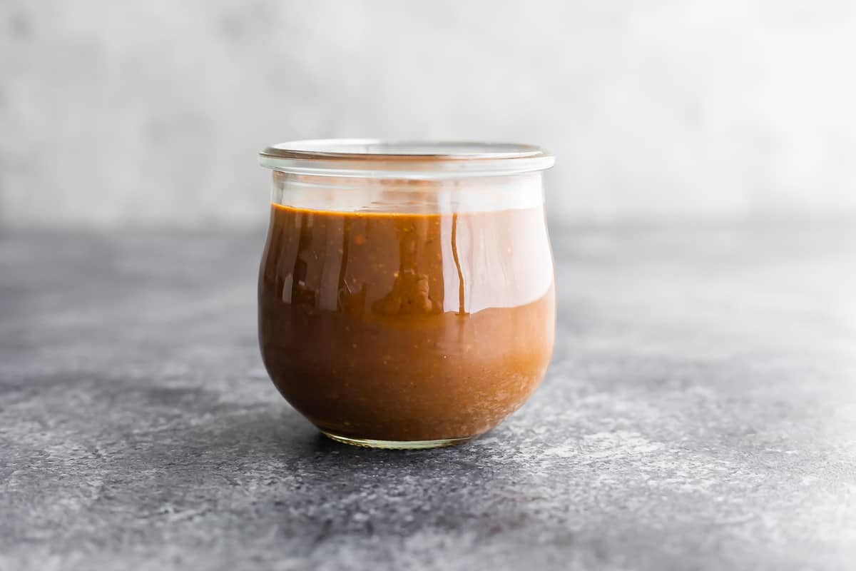 side angle of peanut sauce in jar