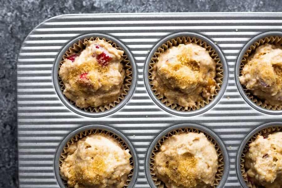 overhead shot of rhubarb muffins in muffin tray before baking